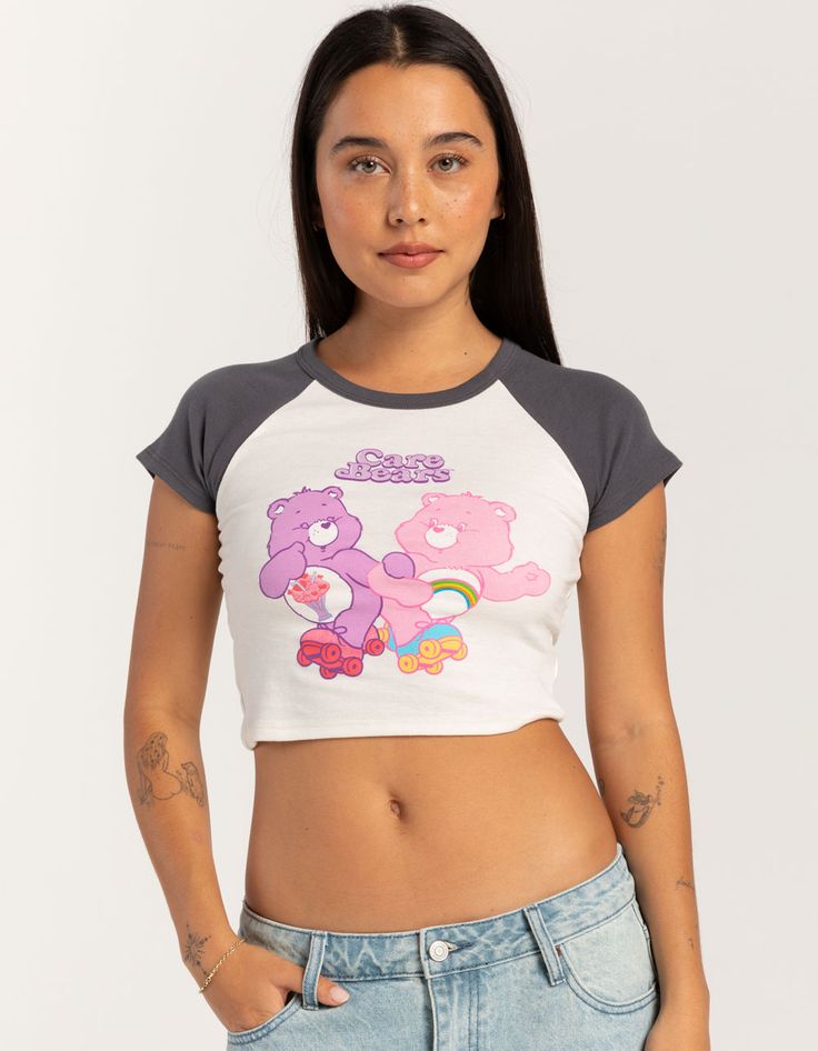 Care Bears Raglan Baby Tee. Large Graphic Screened On Front. Crewneck. Contrast Neckline And Short Sleeves. Shrunken Fit. 50% Cotton, 50% Polyester. Machine Wash. Imported. Model Is Wearing A Size Small. Model Measurements:height: 5'7" Bust: 34"waist: 25"hips: 34.5" Playful White Fitted Top, Playful Fitted Graphic Print Tops, Playful Fitted Crew Neck Top, Playful Fitted White Top, Playful Fitted Top With Graphic Print, Cute Gray Crew Neck Top, Cute Gray Top With Graphic Print, Gray Crew Neck Cute Tops, Playful Cotton Crop Top