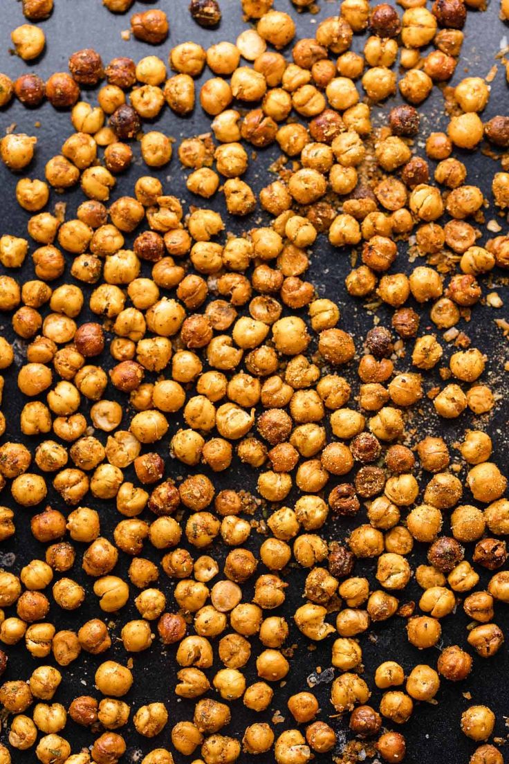 roasted chickpeas on a baking sheet ready to be cooked in the oven for roasting