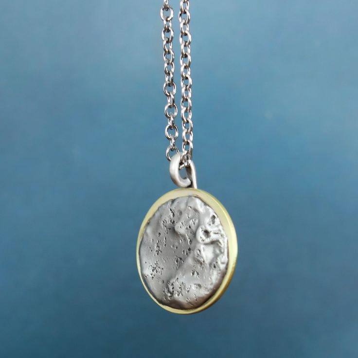 In 2017, the solar eclipse's path of totality found its way to Casper, Wyoming and sparked pure magic. Our Solar Eclipse Necklace is meant to do just that. Inspired by the celestial spectacle, we hope this handmade piece reminds you to look up and see the world through new eyes from time to time. Handcrafted with love in the heart of Wyoming. Necklace Details Pewter & Brass Charm on a dainty bail Sterling silver chain - choose your length Includes jewelry care card & polishing pad Free standard One-of-a-kind Celestial Jewelry Gift, Artisan Moon Phase Jewelry Gift, Hand-cast Round Amulet Jewelry, Unique Moon Phase Pendant Necklace, Eclipse Necklace, Jewelry Care Card, Casper Wyoming, Path Of Totality, Metaphysical Jewelry