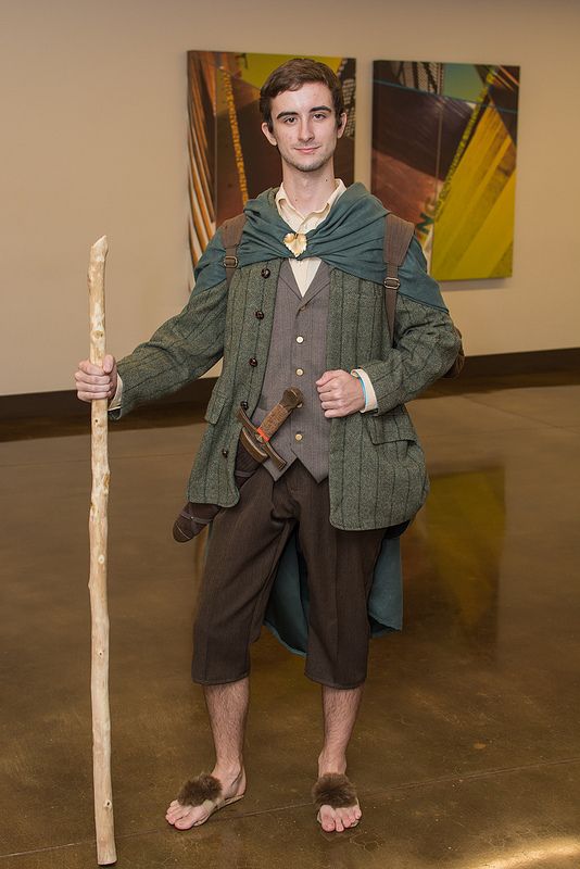 a man dressed in period clothing holding a stick