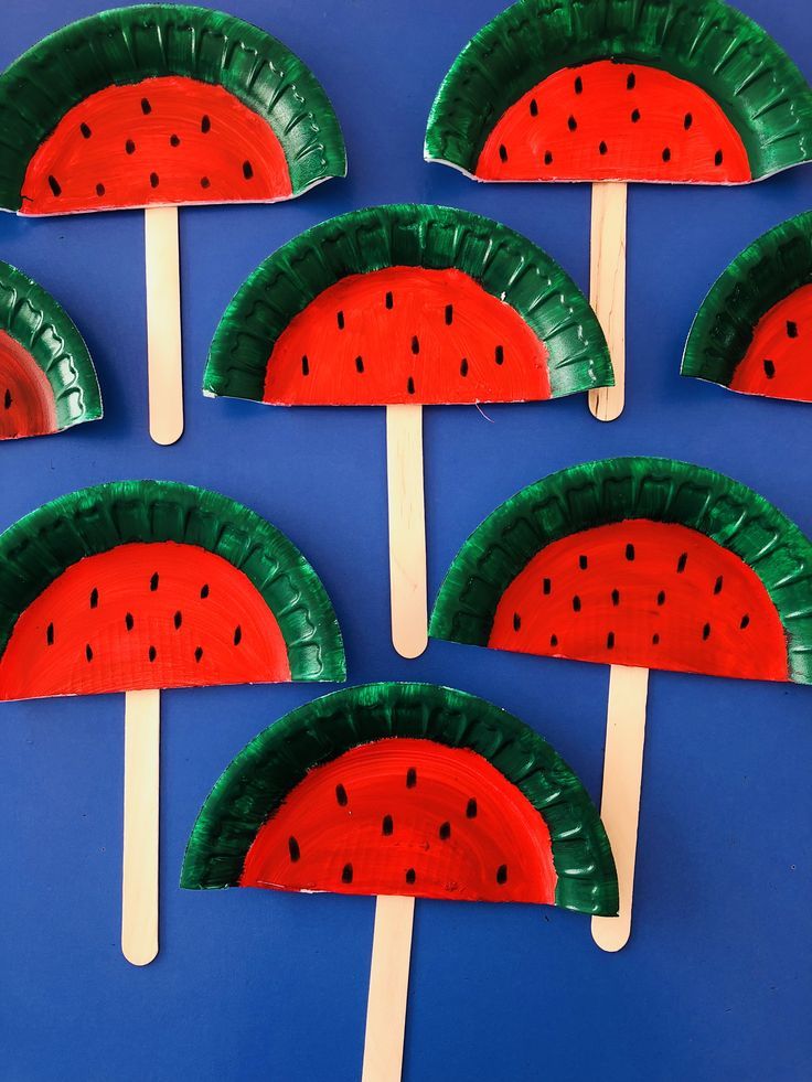 paper plate watermelon popsicles on a blue background