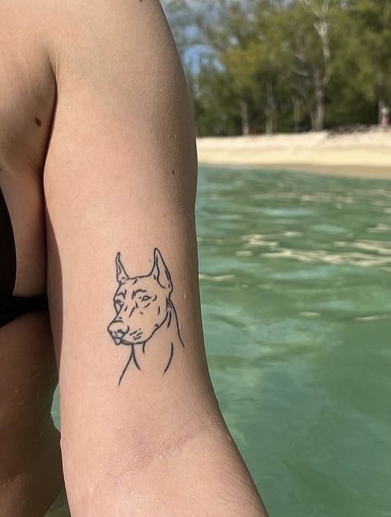 a woman with a dog tattoo on her arm