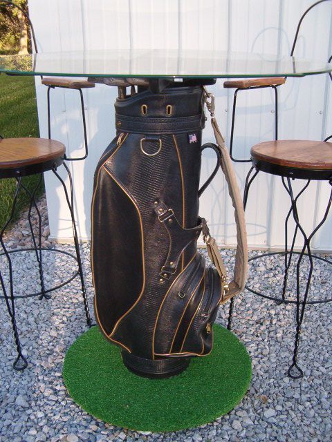 a golf bag sitting on top of a table next to two chairs and a glass table