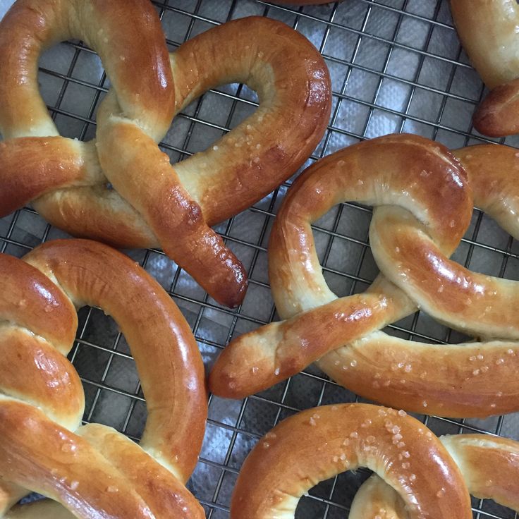 several pretzels on a cooling rack ready to be baked