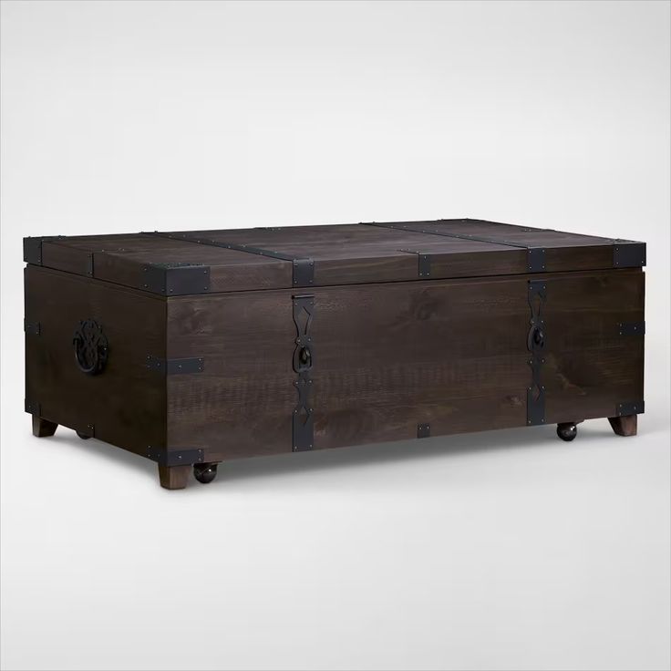 the trunk is made out of wood and has two doors on one side, and an opening at the top