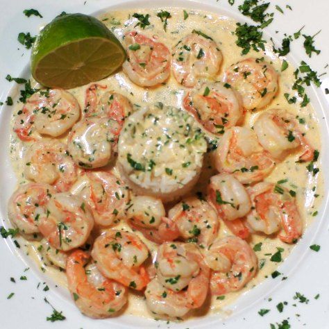 a white plate topped with shrimp and sauce