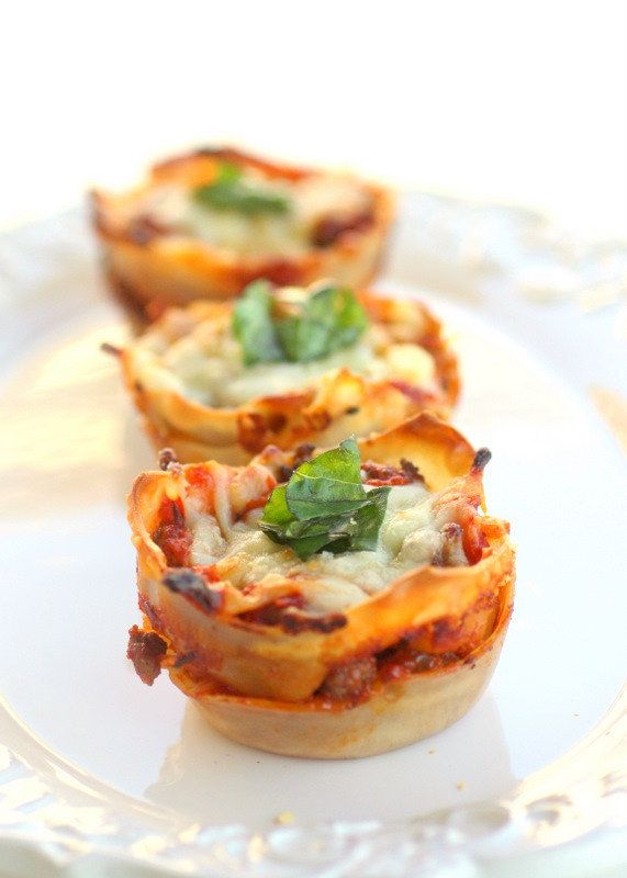 three mini pizzas sitting on top of a white plate