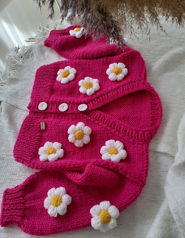 two knitted sweaters with flowers on them