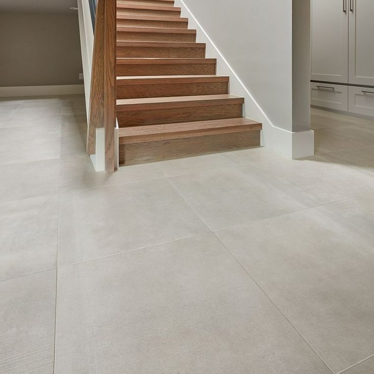 a staircase leading up to the second floor in a modern home with white walls and floors