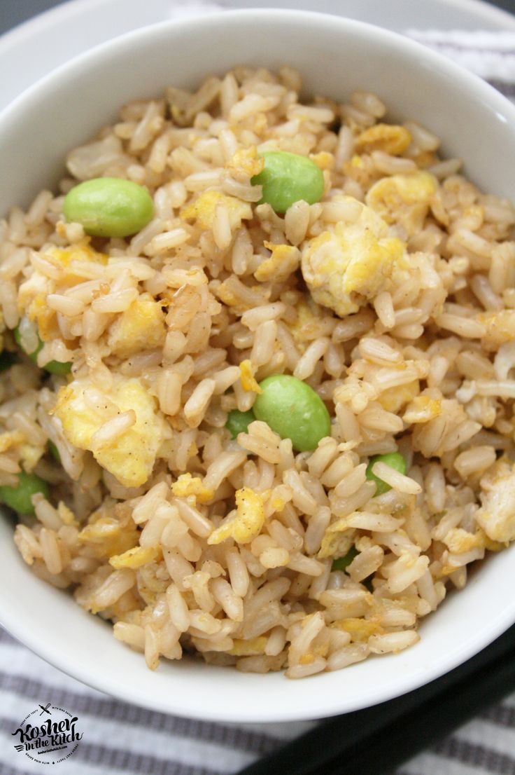 a white bowl filled with rice and peas