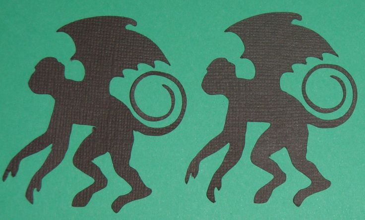 the silhouettes of two monkeys are depicted on a green background