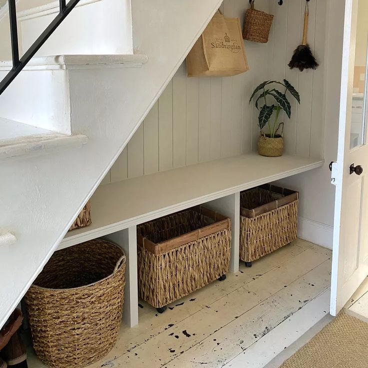 baskets under the stairs in a home