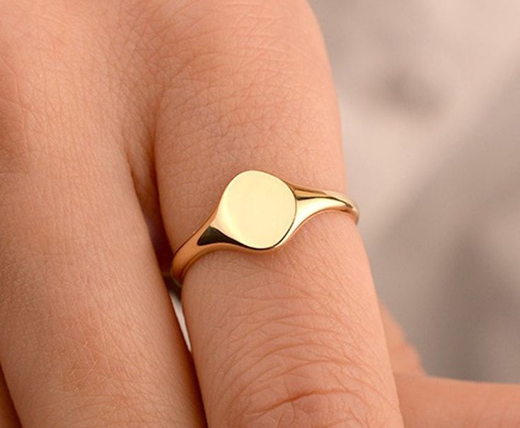 Our circle disc ring is made of 14k solid gold. It fits your all outfit at any time of the day with its minimalist and dainty style. Also, it can be used as a joint ring. You can enter the name, initial, date, or whatever you want on the personalization box. Your name is engraved with a special laser. ( You can see the example of a ring that is engraved with a special laser in the photos.) If you consider it as a gift for special days, it will a perfect choice for your loved ones on their birthd Elegant Round Signet Ring With Simple Design, Dainty Adjustable Signet Ring, Simple Stackable Initial Ring, 14k Gold Stackable Signet Ring, Gold Signet Ring With Simple Design, Simple 14k Gold Signet Ring As Gift, Simple Design Everyday Signet Ring, Simple Round Initial Promise Ring, Gift Midi Rings With Polished Finish