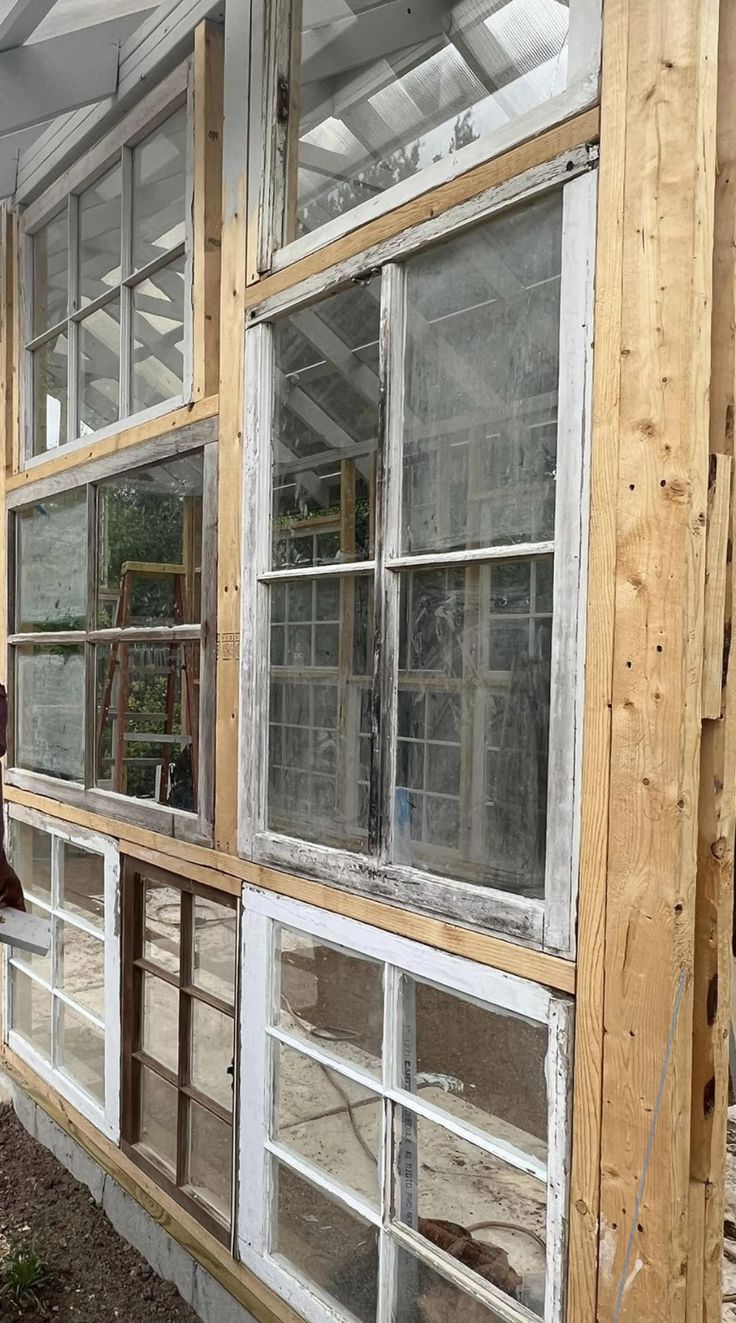 an old window is being installed on the side of a house that's under construction