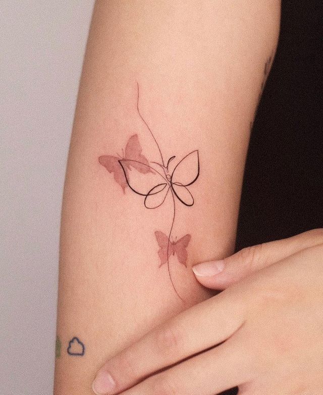 a woman's arm with a butterfly tattoo on it