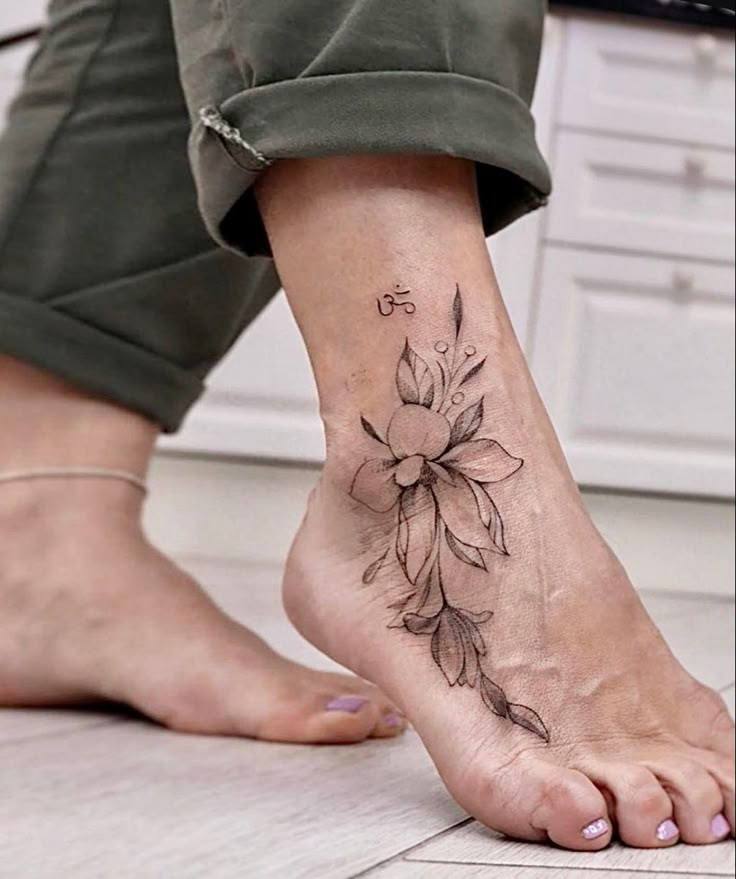 a person with a flower tattoo on their foot