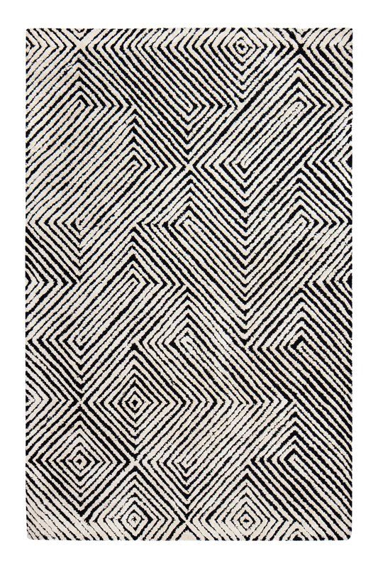 a black and white rug with an abstract design