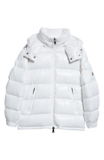 This hooded down puffer jacket crafted from glossy nylon is a contemporary take on an iconic Moncler design. A cockerel logo patch and engraved hardware bring signature touches to the look. Two-way front-zip closure Fixed hood Elastic cuffs Front zip pockets Lined, with down fill 100% polyamide Dry clean Imported Women's Designer Clothing Hooded White Duck Down Puffer Jacket, White Nylon Puffer Jacket With Detachable Hood, Luxury White Puffer Jacket For Winter, Luxury White Winter Puffer Jacket, White Down Puffer Jacket For Streetwear, Luxury White Puffer Jacket With Padded Collar, White Duck Down Outerwear With Detachable Hood, White Hooded Quilted Puffer Jacket, White Duck Down Puffer Jacket With Padded Collar