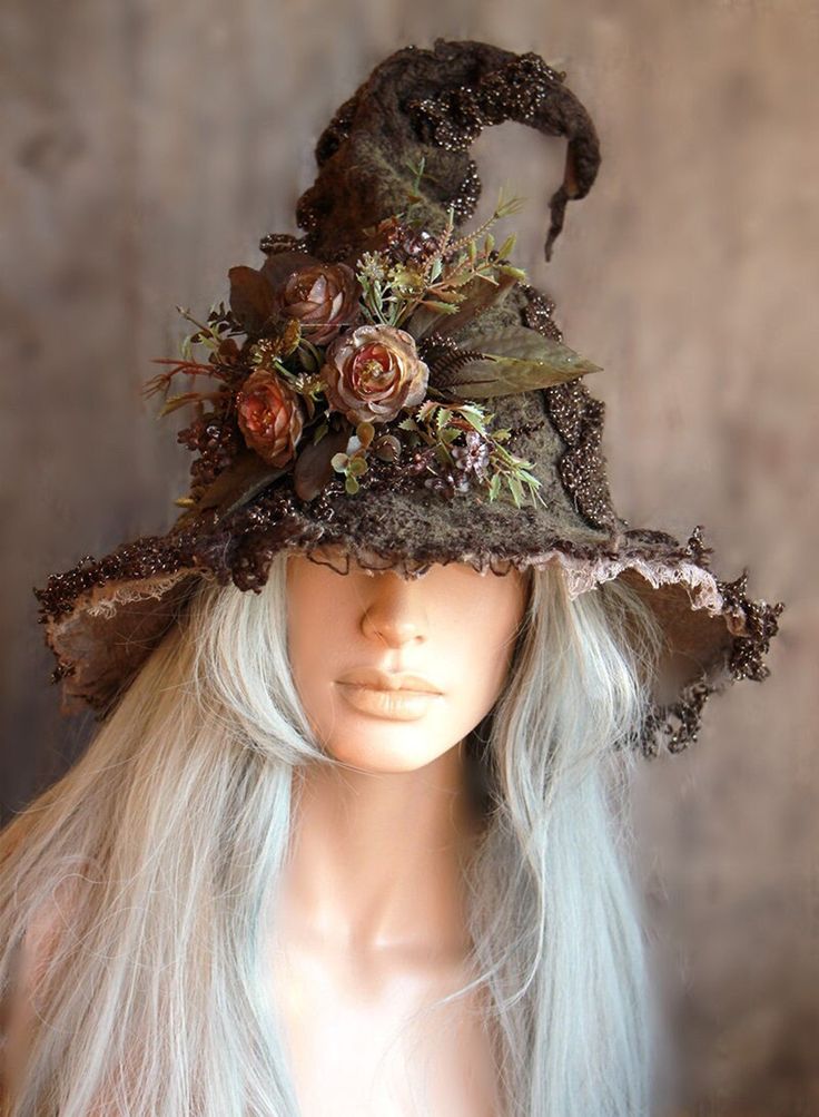 a woman's hat with flowers and leaves on it