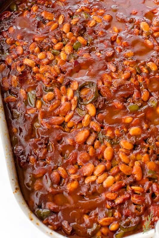 a casserole dish filled with beans and vegetables