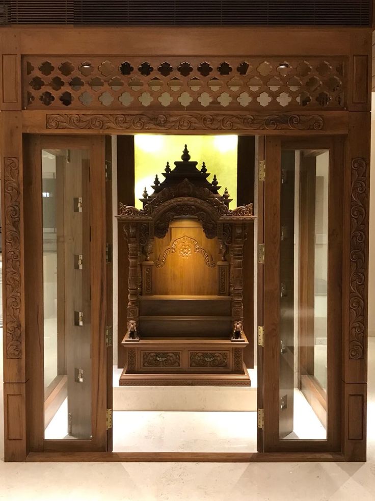 an ornate wooden shrine in the middle of a room