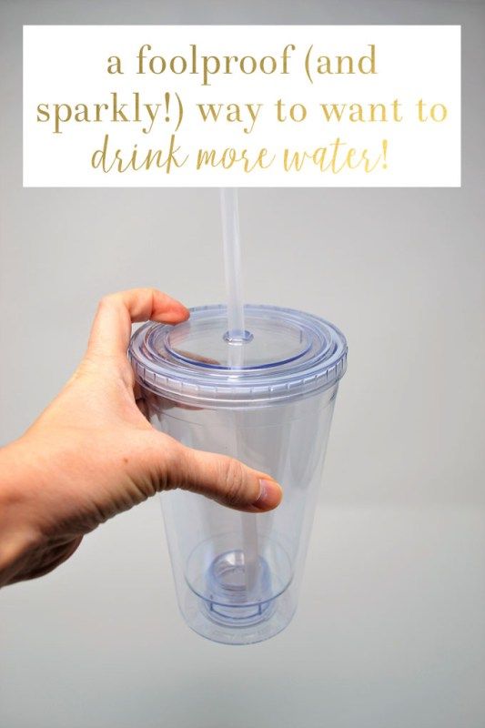 a person holding a plastic cup with a straw in it and the words, a foolproof and sparkly way to want to drink more water