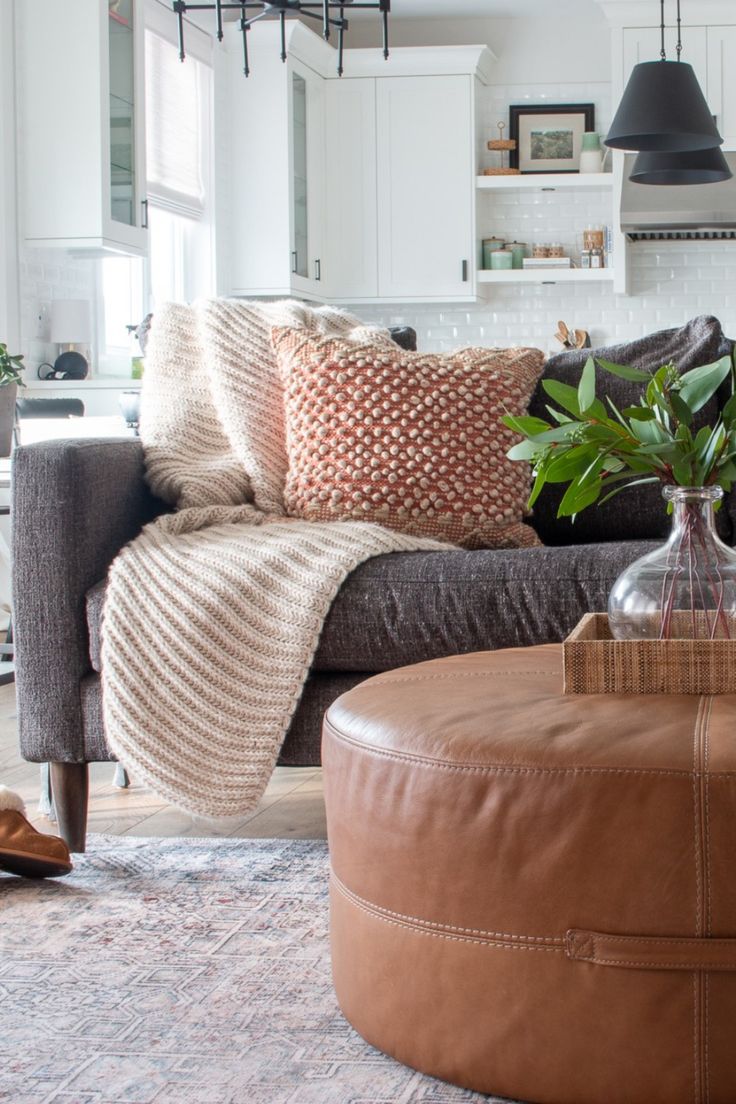 a living room filled with furniture and pillows