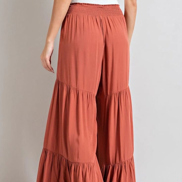 Our Taylor Tiered Pants will make you feel like a boho goddess! These comfy, flowy pants feature wide legs and tiers that flutter and dance as you move. Step out in style; you won't want to take them off!Model is 5'8" wearing a size small 100% rayon - Non-stretch fabric Casual Flowy Bottoms With Ruffles, Casual Flowy Ruffled Bottoms, Flowy Ruffled Casual Bottoms, Bohemian Maxi Bottoms With Ruffles, Bohemian Ruffled Maxi Bottoms, Rayon Tiered Skirt For The Beach, Rayon Tiered Skirt For Beach, Beach Rayon Tiered Skirt, Flowy Rayon Tiered Skirt