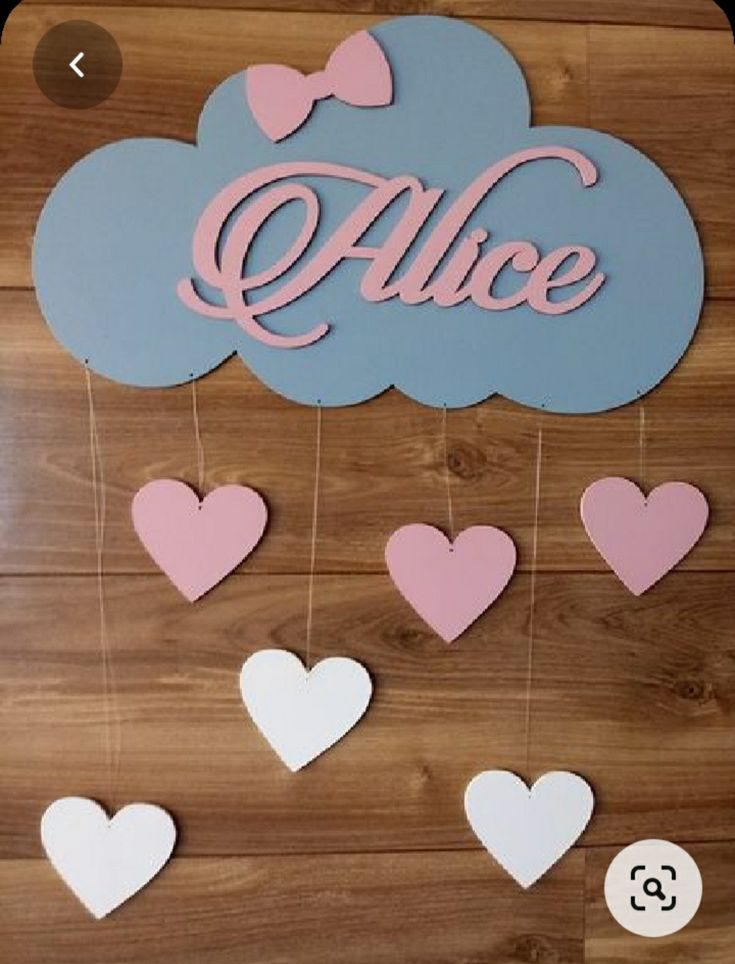 a wooden sign with hearts hanging from it's sides and the word alice above them