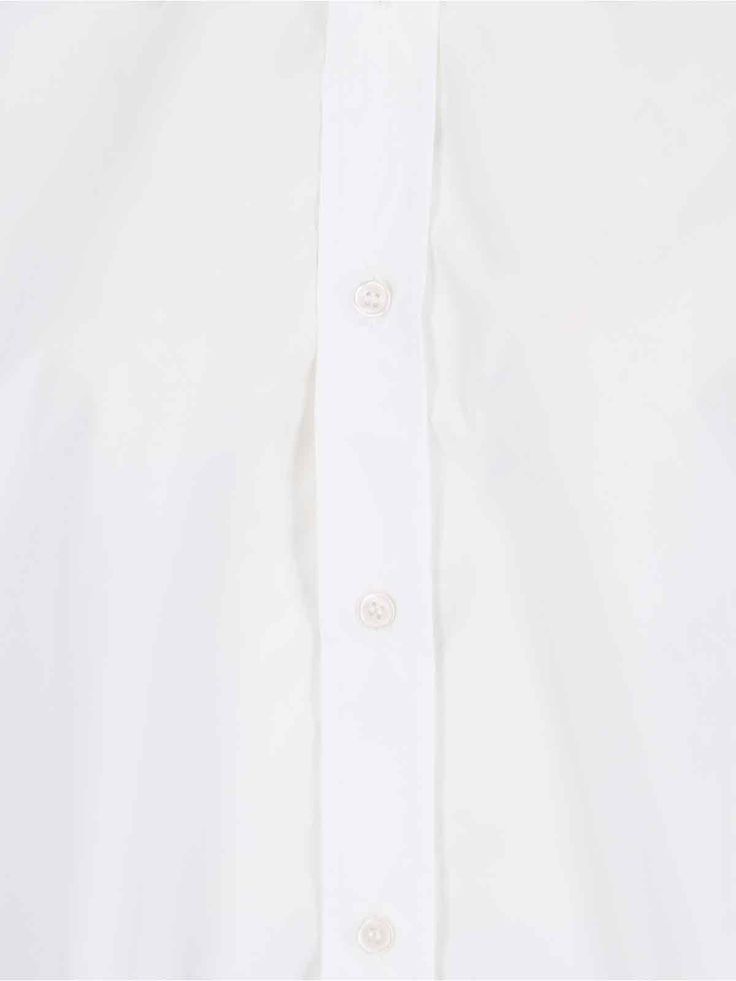 Filippa K Poplin shirt in white cotton poplin with classic collar, button closure, button cuffs, silver metal charm detail, curved hem. Composition: 100% Cotton Modern White Blouse With Concealed Placket, White Blouse With Concealed Placket For Office, White Business Blouse With Placket, White Blouse With Placket For Business, White Blouse With Concealed Placket And Fold-down Collar, Classic Formal Poplin Blouse, Modern White Blouse With Placket, White Poplin Shirt For Work, Elegant Poplin Shirt For Office