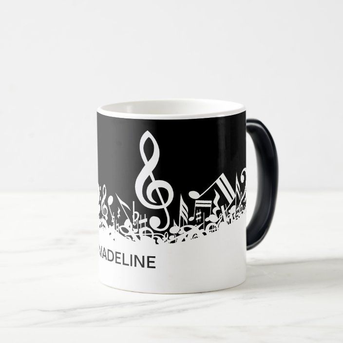 a black and white coffee mug with music notes