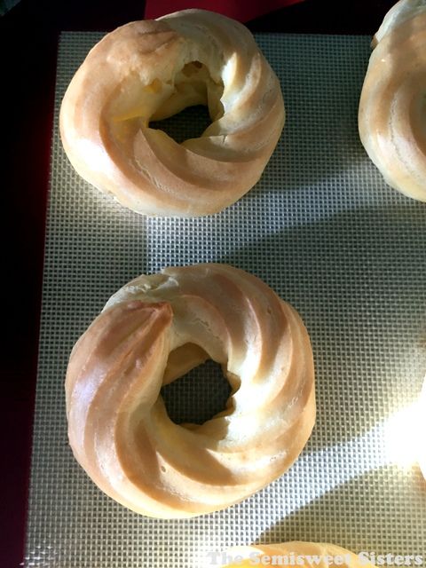 four doughnuts sitting on top of a cookie sheet