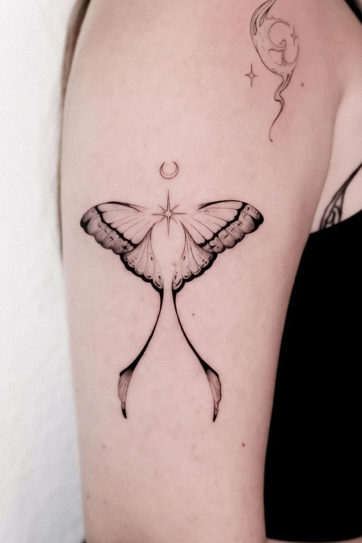 a woman's arm with a butterfly tattoo on the left side of her body