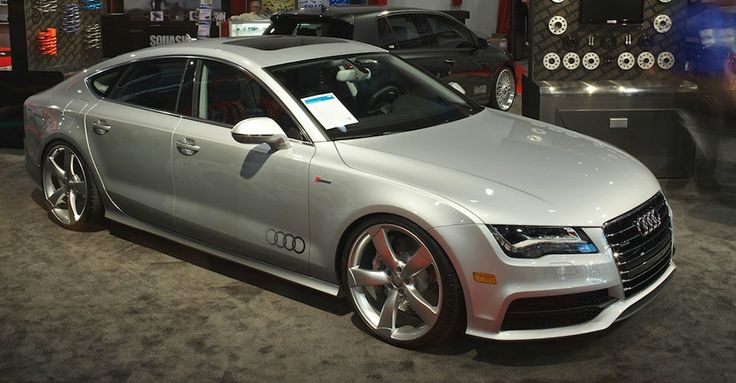 a silver car is on display in a showroom