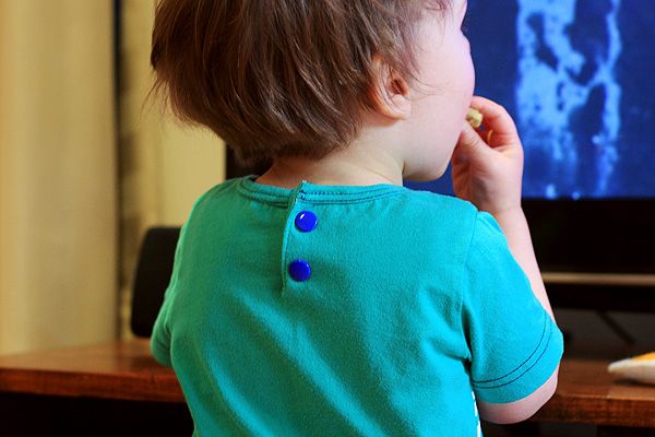 a little boy that is sitting in front of a tv