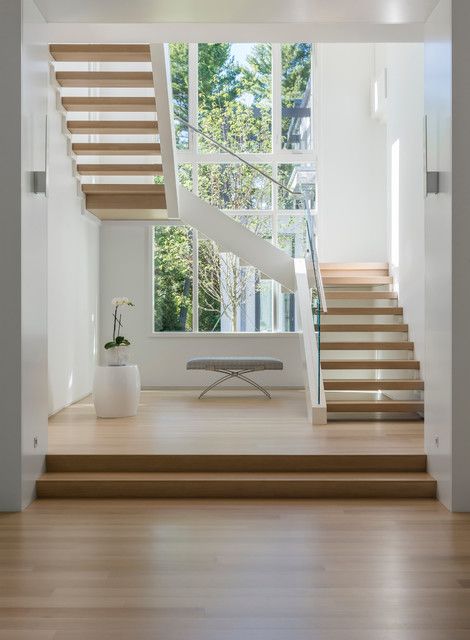 the stairs in this house are made of wood and have been painted white with wooden treads