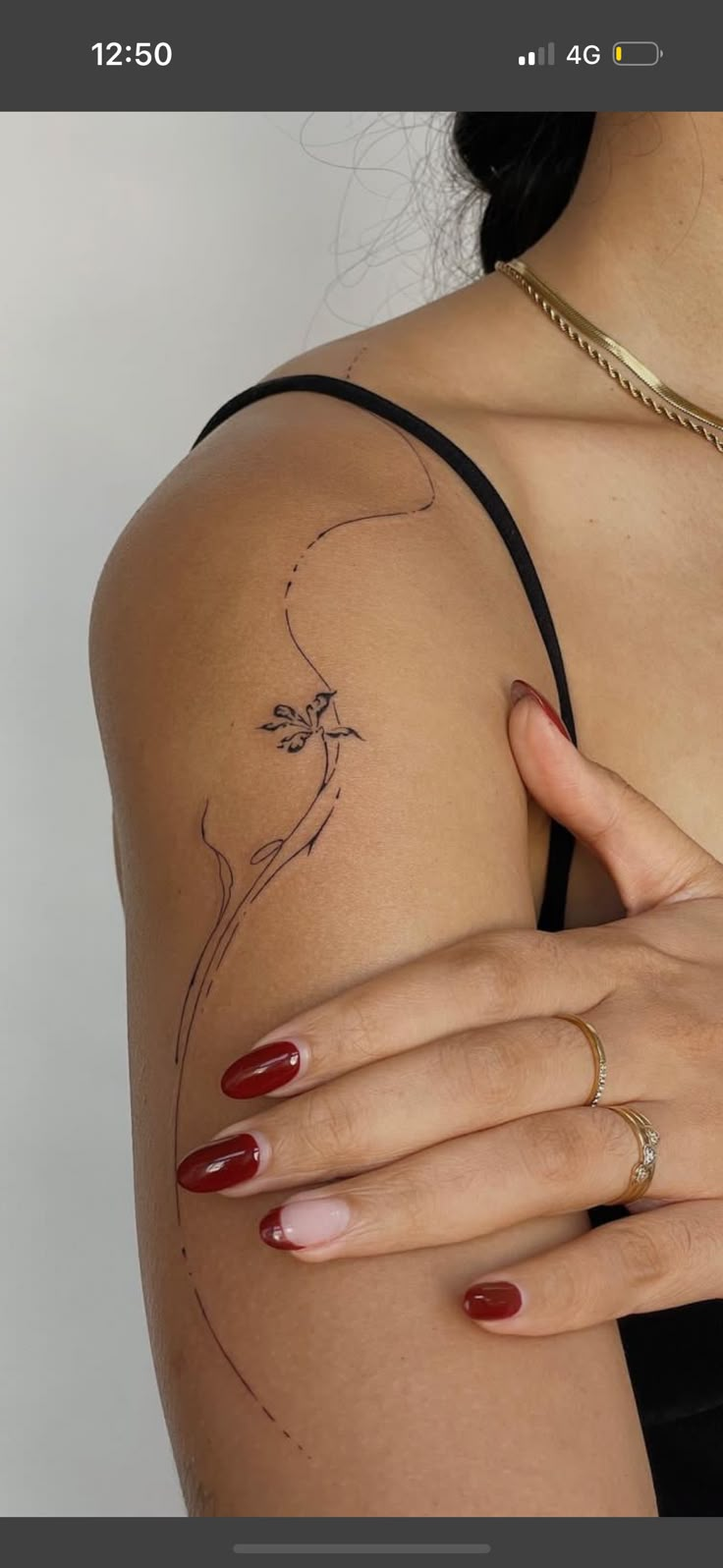 a woman's arm with a flower tattoo on the left side of her arm