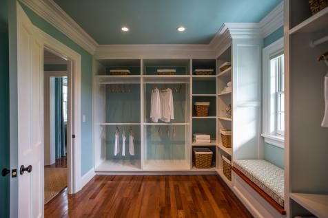 an empty walk in closet with wooden floors