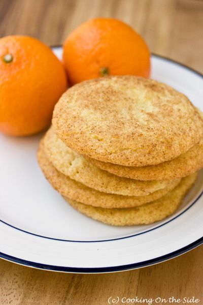 some oranges and cookies on a white plate