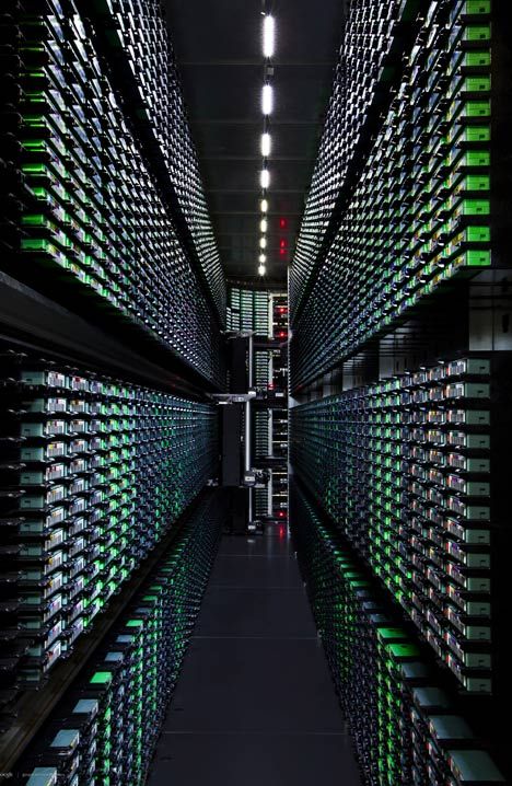 rows of wine bottles are lined up in a dark room with lights on the ceiling