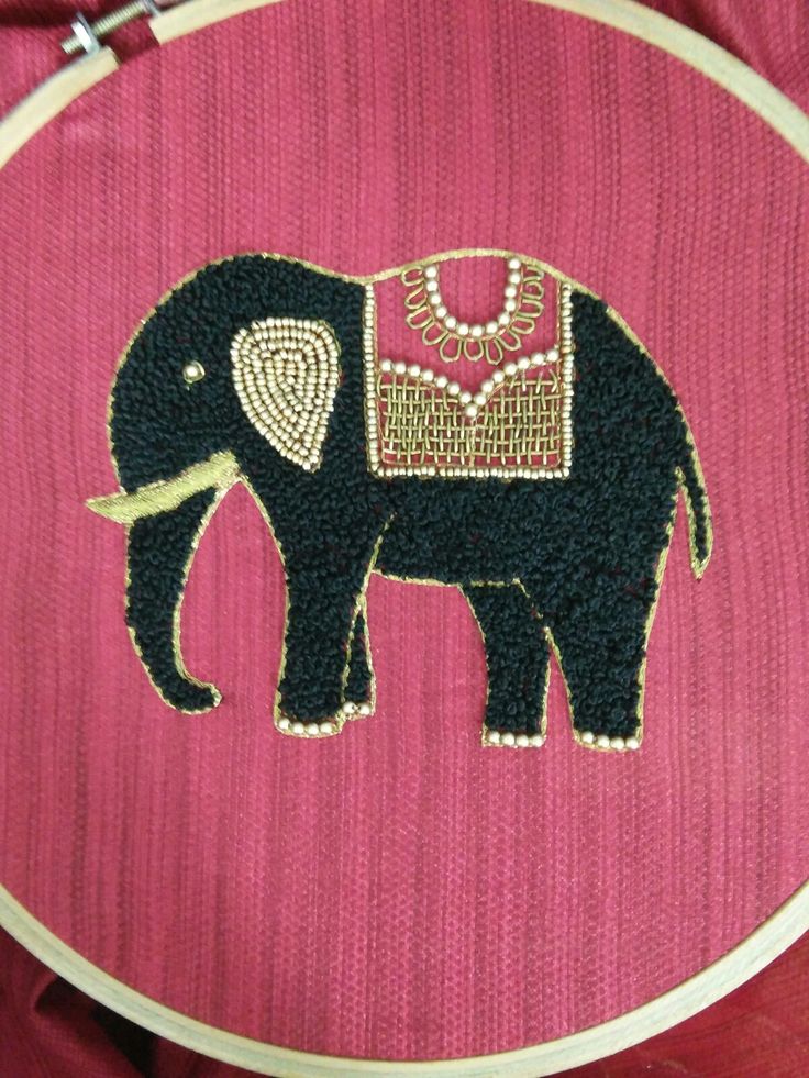 an elephant is embroidered onto a pink background