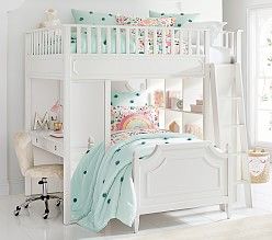 a white bunk bed sitting in a bedroom next to a window