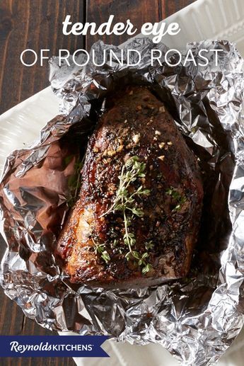 the tender eye of round roast in foil on a white plate with text overlay that reads, tender eye of round roast