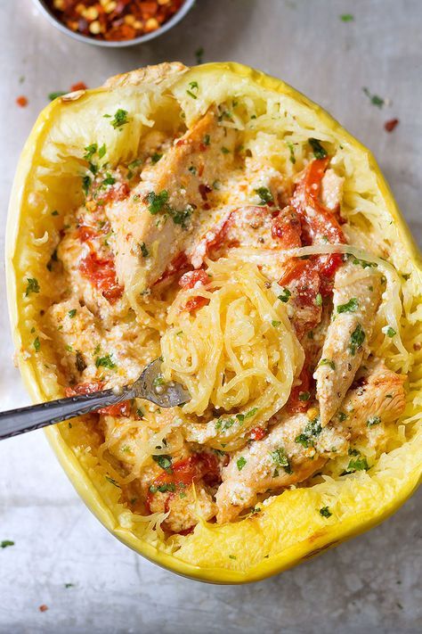 an overhead view of spaghetti and chicken in a yellow squash dish with a side of chickpeas