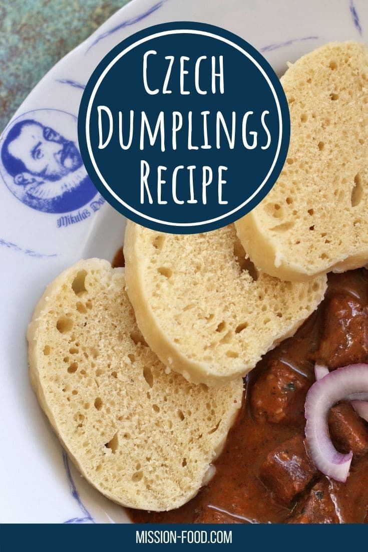 a plate topped with meat and bread on top of a blue and white table cloth