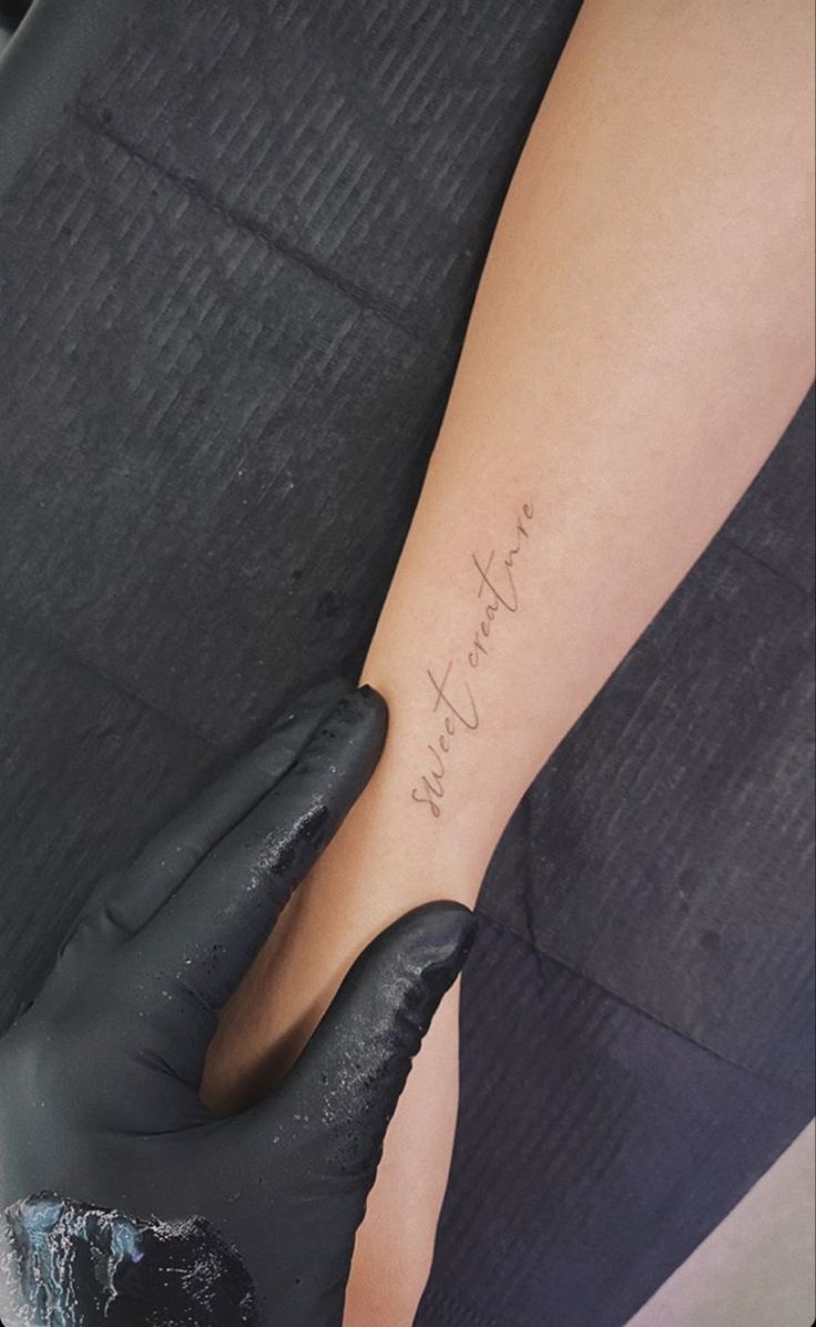 a woman's arm with the words, i love you written on it in cursive writing