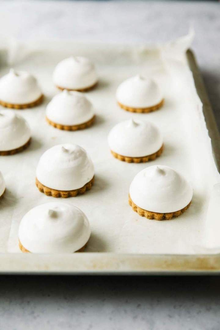 a tray filled with cookies covered in white icing