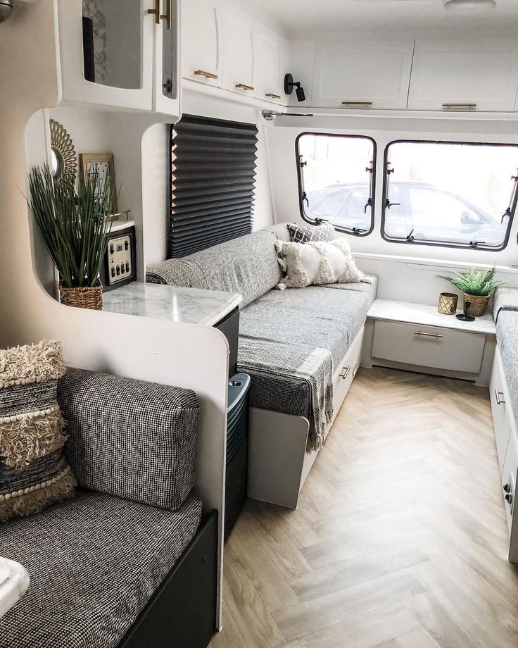 the interior of a camper with two couches and a kitchenette in it