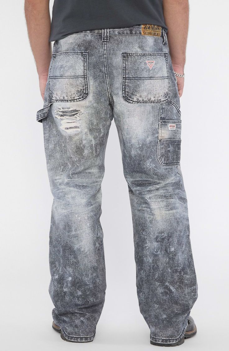 A vintage-inspired take on the utility trend, these distressed nonstretch carpenter jeans feature a low-rise waist, full-length wide legs and a paneled design. 32" inseam; 19" leg opening; 12 1/4" front rise; 16" back rise Front slant pockets; back patch pockets 100% cotton Machine wash, tumble dry Imported Utility Style Faded Jeans With Five Pockets, Utility Style Faded Jeans, Distressed Rugged Bottoms With Relaxed Fit, Rugged Distressed Straight Leg Bottoms, Rugged Distressed Medium Wash Bottoms, Rugged Medium Wash Distressed Bottoms, Rugged Distressed Dark Wash Bottoms, Utility Distressed Straight Leg Jeans, Distressed Denim Rugged Bottoms