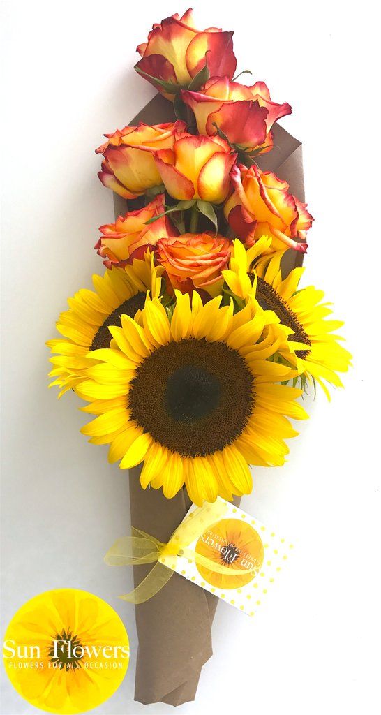 a bouquet of sunflowers and orange roses in a vase on a white background